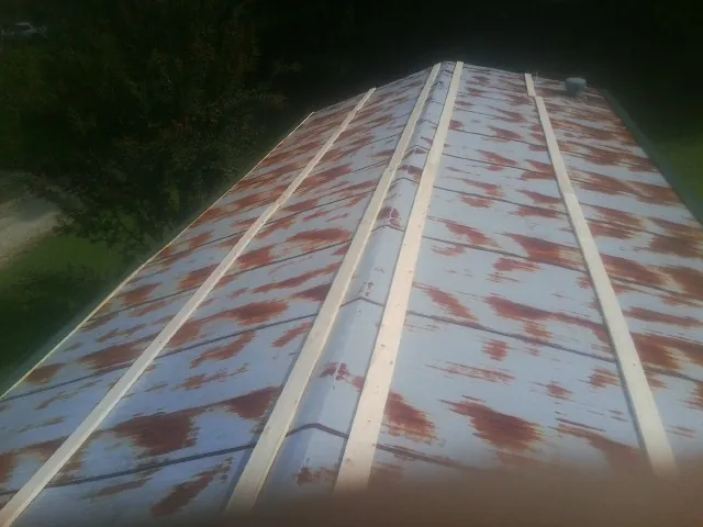 Rusted metal roof panels with new wood purlins before replacement — Storm Damage Roof Repair in Ridge by Roofing Brothers